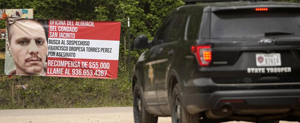 A Texas state trooper vehicle passes a posted wanted sign for a mass shooting suspect Tuesday, May 2, 2023, in the neighborhood where the shooting occurred last week, in Cleveland, Texas. Five people were killed when the suspected gunman, Francisco Oropeza, allegedly shot his neighbors after they asked him to stop firing off rounds in his yard. (AP Photo/David J. Phillip)