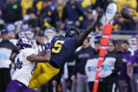 Michigan wide receiver Mike Sainristil (5), defended by Northwestern defensive back Rod Heard II (24) stretches but is unable to catch the pass during the second half of an NCAA college football game, Saturday, Oct. 23, 2021, in Ann Arbor, Mich. (AP Photo/Carlos Osorio)