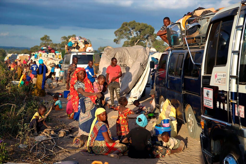 This undated photo provided on Thursday, Oct. 13, 2022 by Doctors Without Borders (MSF) shows people displaced by the conflict in Cabo Delgado Province Mozambique, next to a truck on the outskirts of Mueda, Mozambique, waiting to be transported to reach Palma, a coastal town that was attacked earlier this year and where some people have already gradually returned. (Igor Barbero/Doctors Without Borders (MSF) via AP)