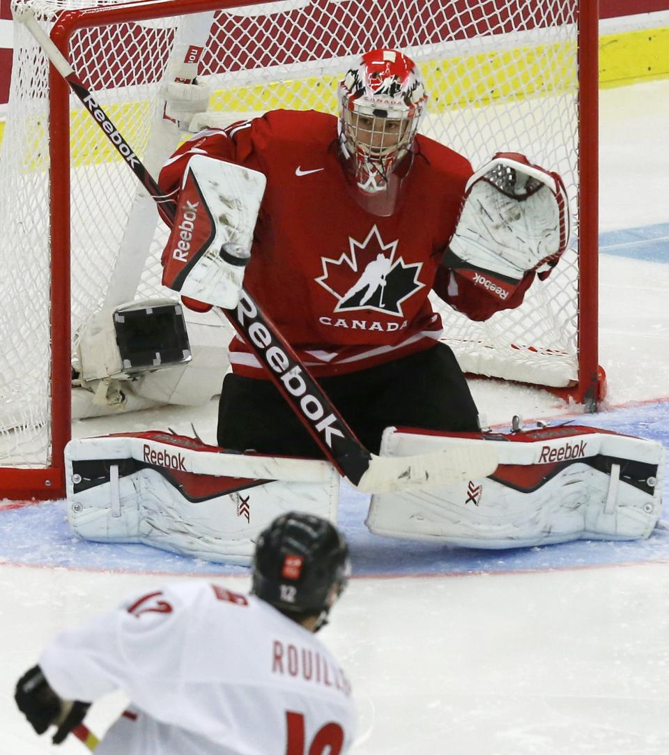 Canada's goalie Zachary Fucale makes a save on Switzerland's Anthony Rouiller during the third period of their IIHF World Junior Championship quarter-final ice hockey game in Malmo, Sweden, January 2, 2014. REUTERS/Alexander Demianchuk (SWEDEN - Tags: SPORT ICE HOCKEY)