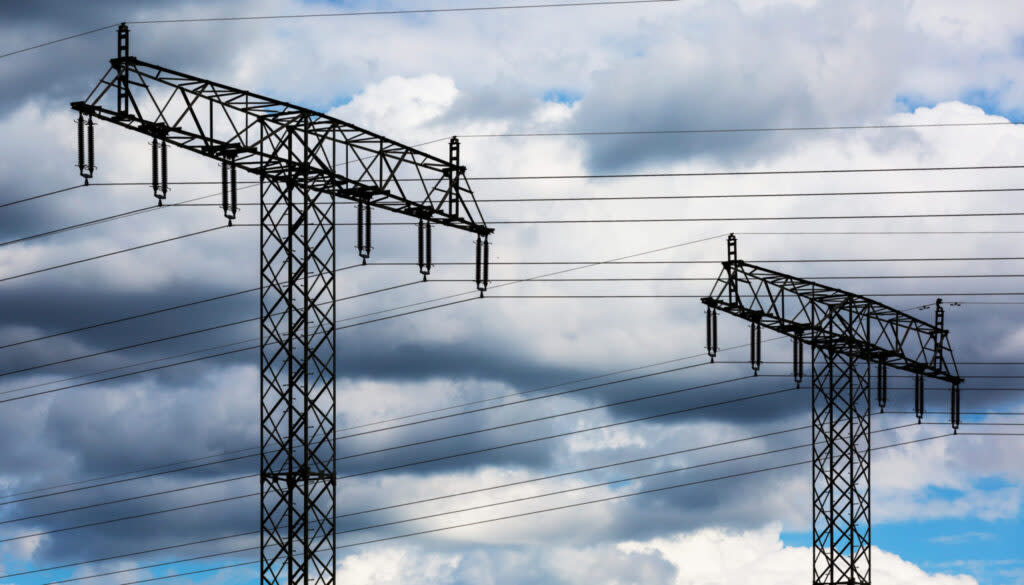 Electricity pylons against a cloudy sky
