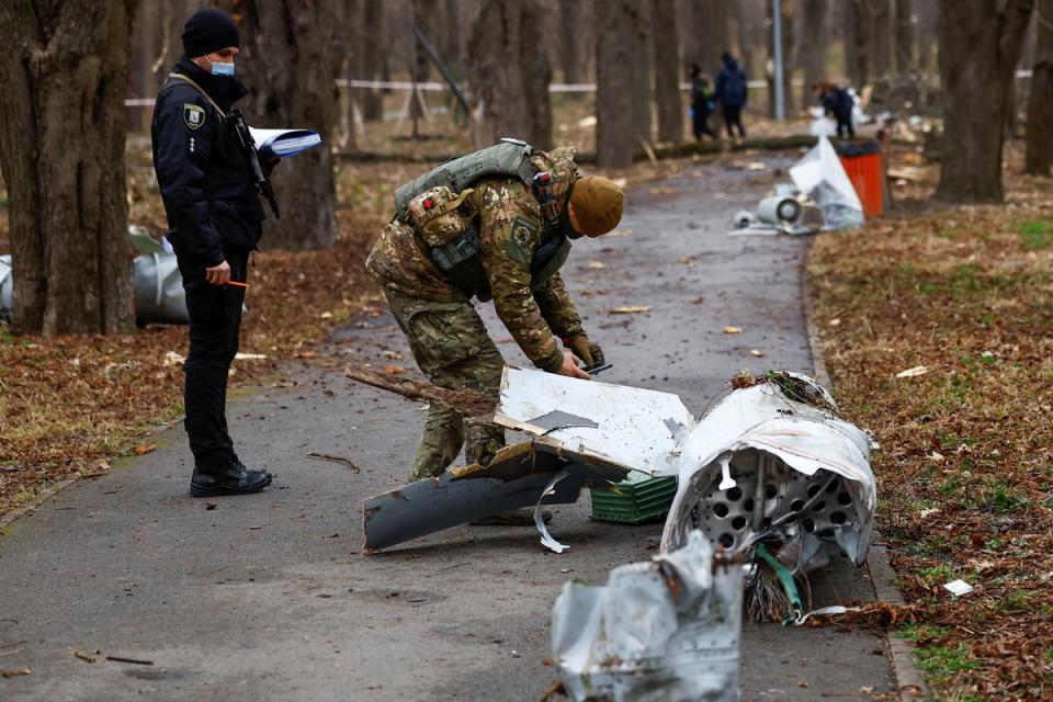 Police officers inspect a part of a Russian Kh-55 cruise missile, intercepted during a missile strike (Reuters)