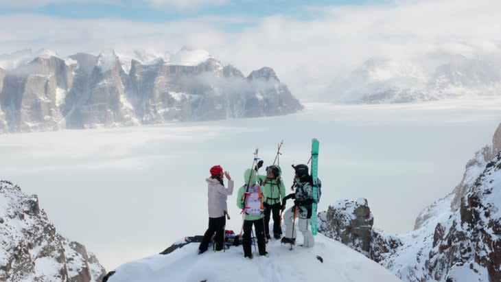 A wide shot of four women--Hilaree Nelson, Emily Harrington, Christina Lustenburger, and Brette Harrington--wearing skiing and climbing gear in a snowy landscape.