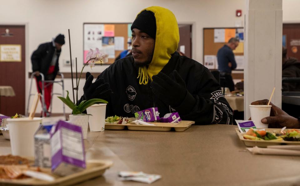 Lequan Riley sits inside Capuchin Soup Kitchen during their food service in Detroit on Thursday, Dec. 7, 2023.