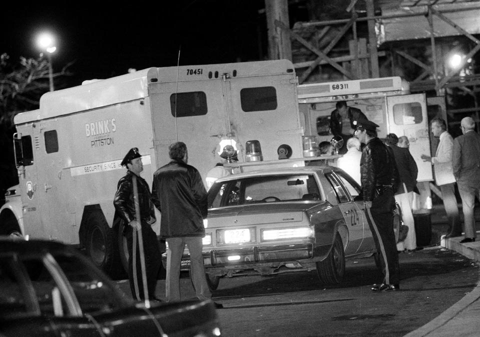 FILE - In this Oct. 21, 1981, file photo, police are at the scene of a Brinks armored truck robbery at the Nanuet Mall in Nanuet, N.Y., where multiple Nyack police officers and a Brinks guard were killed earlier during the robbery. Judith Clark is a former Weather Underground member who has served 35 years of a 75-year-to-life sentence for her role in the robbery, will be eligible for parole in 2017 following a commutation from New York Gov. Andrew Cuomo on Friday, Dec. 30, 2016. (AP Photo/File)