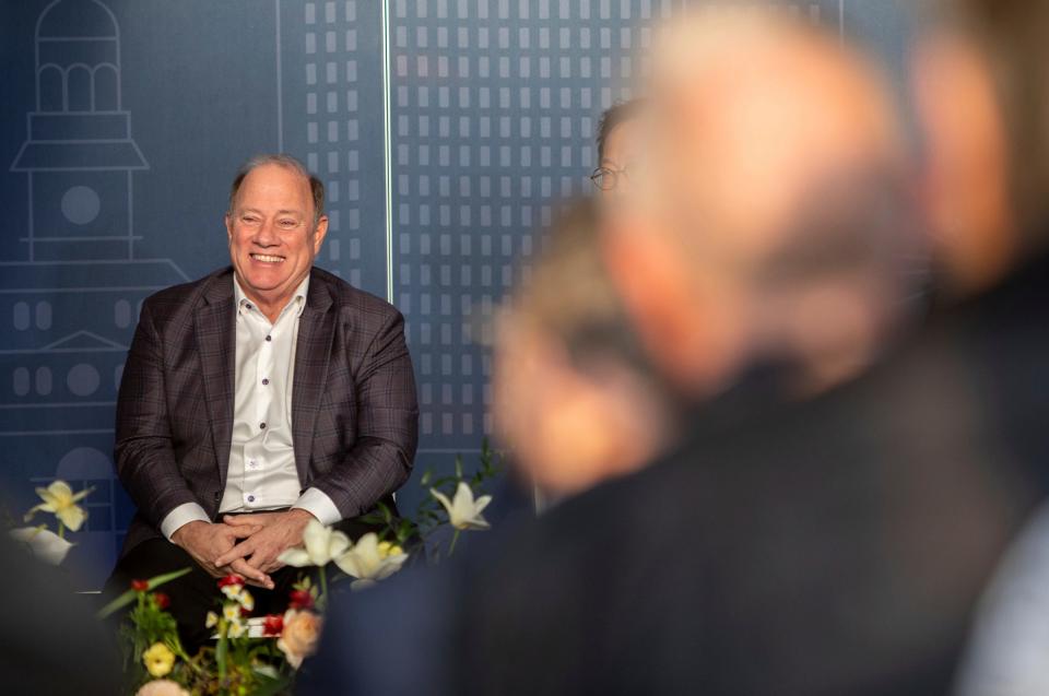Mayor Mike Duggan smiles as he sits in front of media and community members during the groundbreaking event for the University of Michigan Center for Innovation in Detroit on Thursday, Dec. 14, 2023.