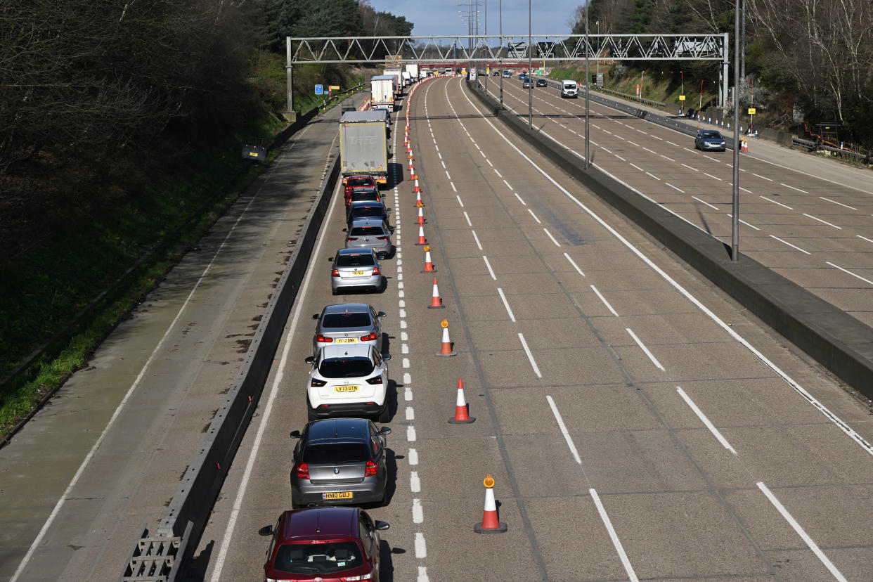 Vehicles are seen queuing to leave the carriageway at Junction 10 of the London orbital motorway the M25, near Cobham, south-west of London on March 16, 2024, as the motorway sees it's first total closure over a weekend since it's opening in 1986. The M25 will be closed between junctions 10 and 11 from Friday 15 March evening until Monday 18 March morning to demolish the Clearmount bridleway bridge and install a very large gantry. (Photo by JUSTIN TALLIS / AFP) (Photo by JUSTIN TALLIS/AFP via Getty Images)