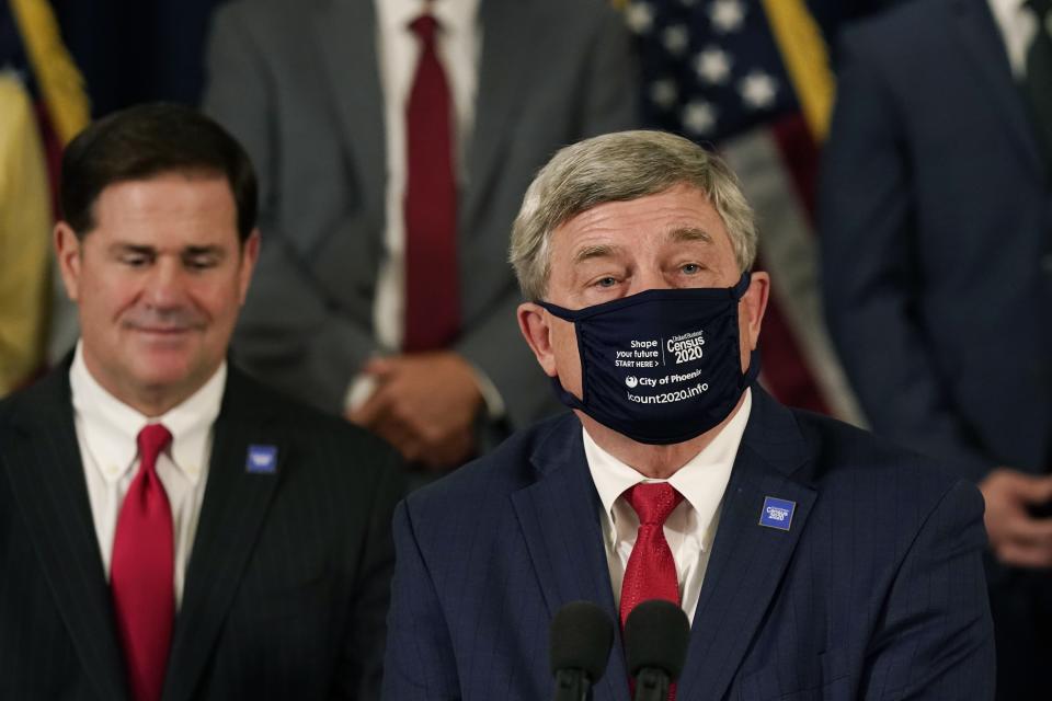 U.S. Census Director Steven Dillingham, right, joins Arizona Gov. Doug Ducey, left, as they hold a census-related news conference to urge Arizonans to participate in the nation's once-a-decade census population count Thursday, Sept. 17, 2020, in Phoenix. Ending the 2020 census at the end of September instead of the end of October, could cost Florida and Montana congressional seats and result in Texas, Florida, Arizona, Georgia, and North Carolina losing $500 million in federal funding for healthcare for its neediest residents. (AP Photo/Ross D. Franklin, Pool)