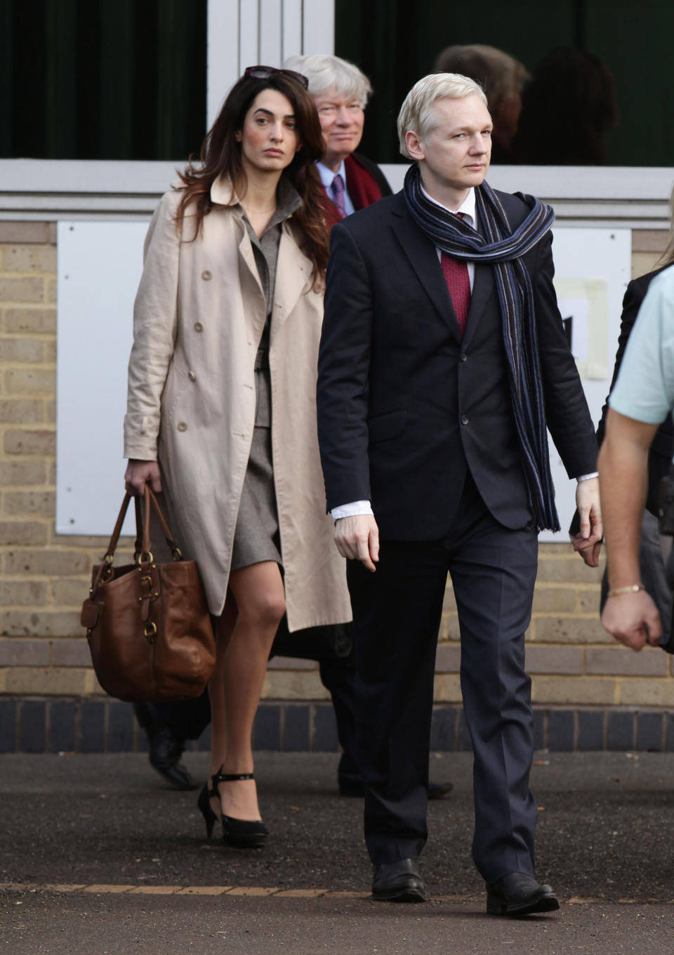 FILE - In this Thursday, Nov 24, 2011 file photo, lawyer Amal Alamuddin, left, is seen walking alongside WikiLeaks founder Julian Assange as they leave Belmarsh Magistrates Court in south east London after his extradition hearing to Sweden to be prosecuted over claims of sexual assault. Hollywood's most eligible bachelor may be getting hitched. A London law firm on Monday April 28, 2014, has congratulated one of its lawyers Amal Alamuddin on her engagement to George Clooney. (AP Photo/Yui Mok, PA Wire, file) UNITED KINGDOM OUT - NO SALES - NO ARCHIVES