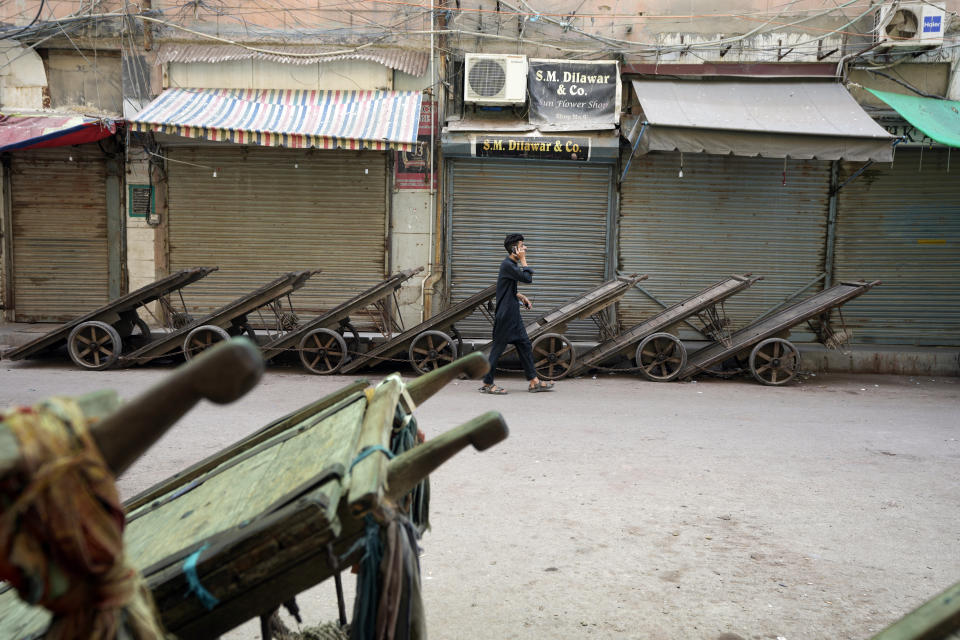 Pakistani shopkeepers close their businesses during strike against inflation in Karachi, Pakistan, Saturday, Sept. 2, 2023. Pakistani traders on Saturday went on strike against the soaring cost of living, including higher fuel and utility bills and record depreciation of the rupee against the dollar, which has led to widespread discontent among the public. (AP Photo/Fareed Khan)