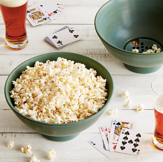 IT'S GENIUS. <a href="https://www.uncommongoods.com/product/the-popcorn-bowl-with-kernel-sifter" target="_blank">Shop it here</a>.&nbsp;