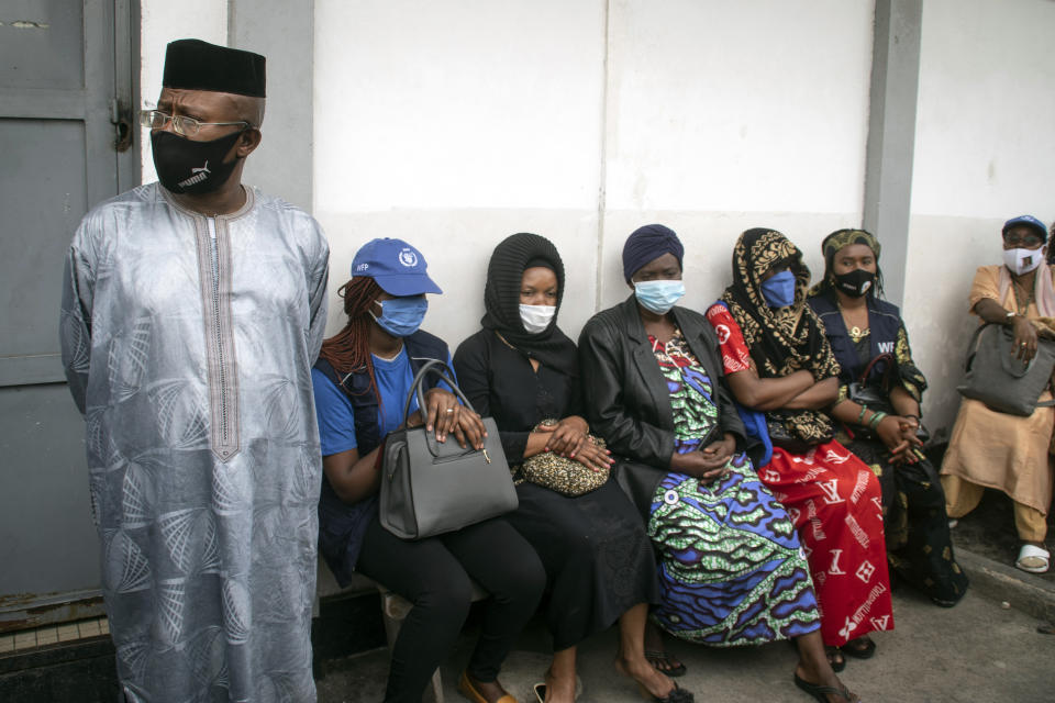 The family of World Food Programme (WFP) driver Moustapha Milambo, who was killed in the attack on a U.N. convoy that also killed the Italian ambassador to Congo and an Italian Carabinieri police officer, wait to receive his body at the morgue in Goma, North Kivu province, Congo Tuesday, Feb. 23, 2021. An Italian Carabinieri unit is expected in Congo Tuesday to investigate the killings of the Italian ambassador to Congo, an Italian Carabinieri police officer and their driver in the country's east. (AP Photo/Justin Kabumba)