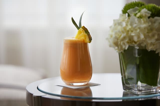 <p>Courtesy of The Peninsula Hotels</p> An energizing smoothie with banana, pineapple, almond milk, carrot juice, ginger, and turmeric, on the Naturally Peninsula menu offered at The Peninsula New York.