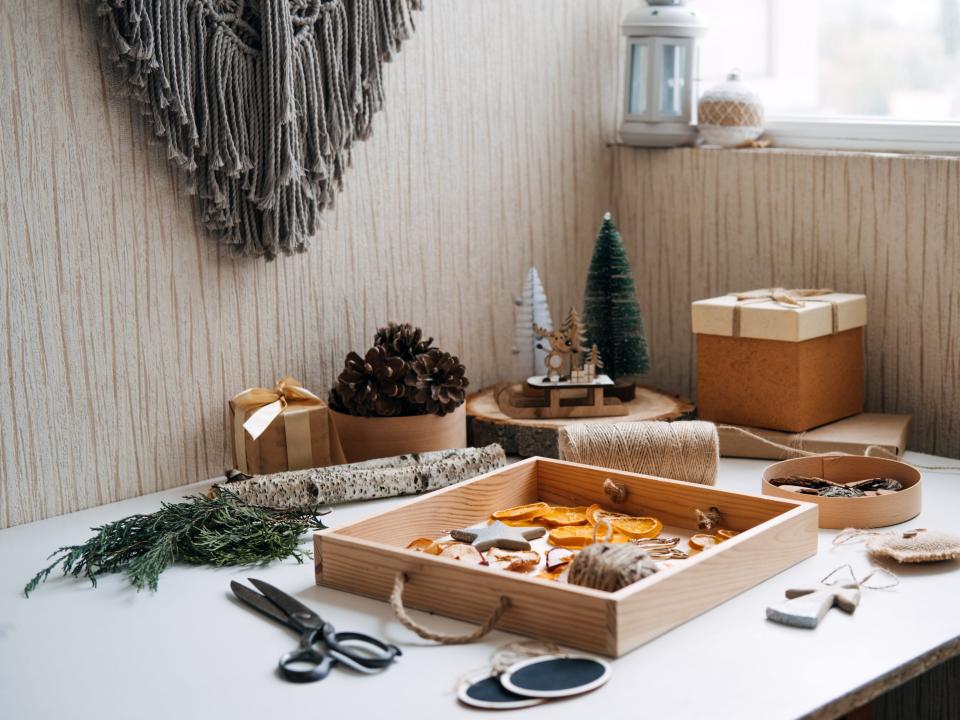 Eco friendly zero waste dried orange slices and DIY tools and stuff on the table. Handmade dried orange for Christmas decorations and Christmas presents.