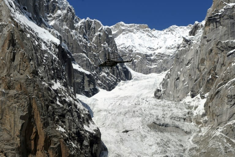 A Pakistan Army helicopter flies over the site of an avalanche over Gayari camp near the Siachen Glacier on April 18, 2012