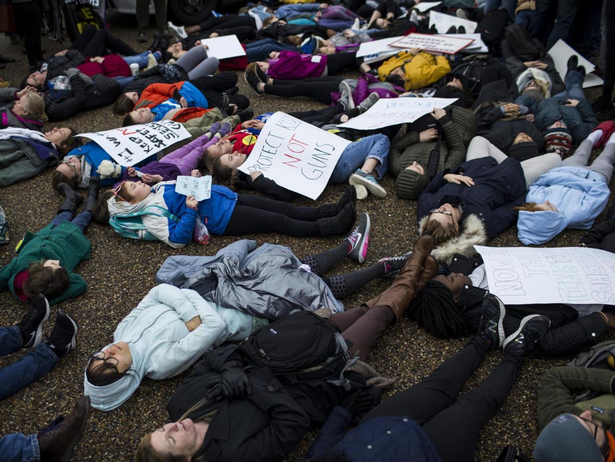 Demonstrators lie on the ground a "lie-in" protest near the White House supporting gun control reform: Getty Images North America