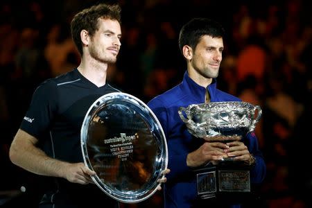 Serbia's Novak Djokovic (R) poses with Britain's Andy Murray while holding the men's singles trophy after winning their final match at the Australian Open tennis tournament at Melbourne Park, Australia, January 31, 2016. REUTERS/Jason O'Brien Action Images via Reuters