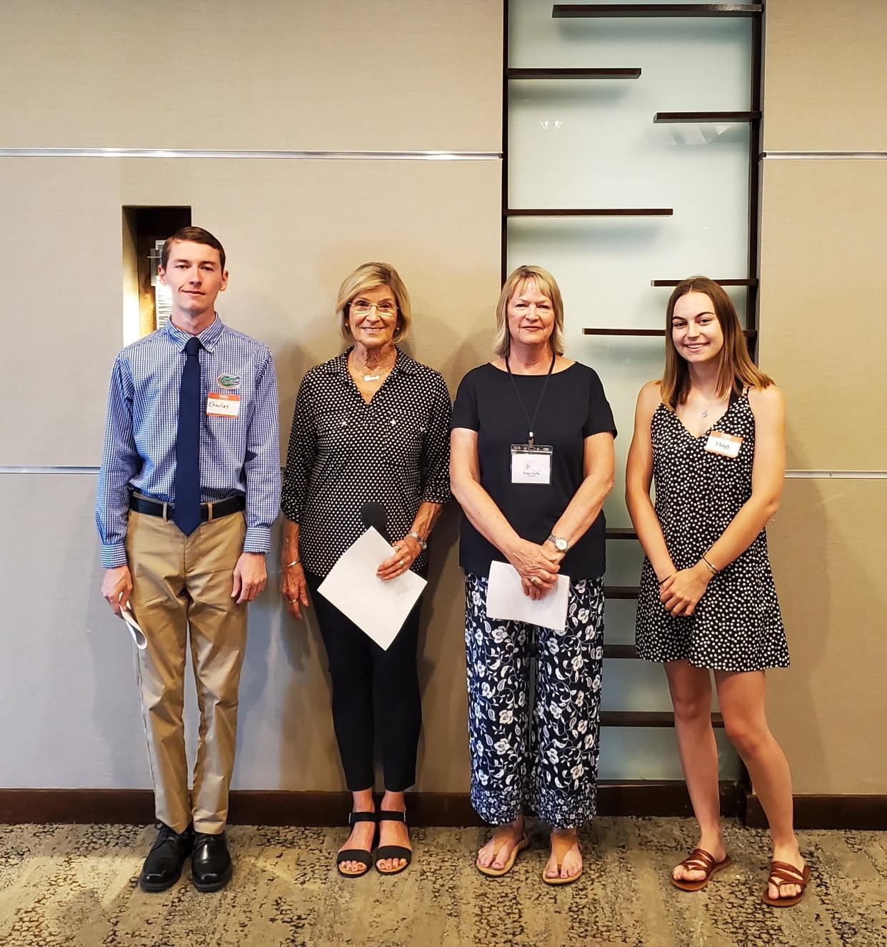 The Sarasota Orchid Society recently awarded their Monroe Kokin scholarships to Maya Lander and Charles Foster.