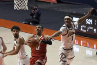 Wisconsin's guard D'Mitrik Trice goes to the basket as Illinois guards Trent Frazier (1) and Jacob Grandison defends in the first half of an NCAA college basketball game Saturday, Feb. 6, 2021, in Champaign, Ill. (AP Photo/Holly Hart)