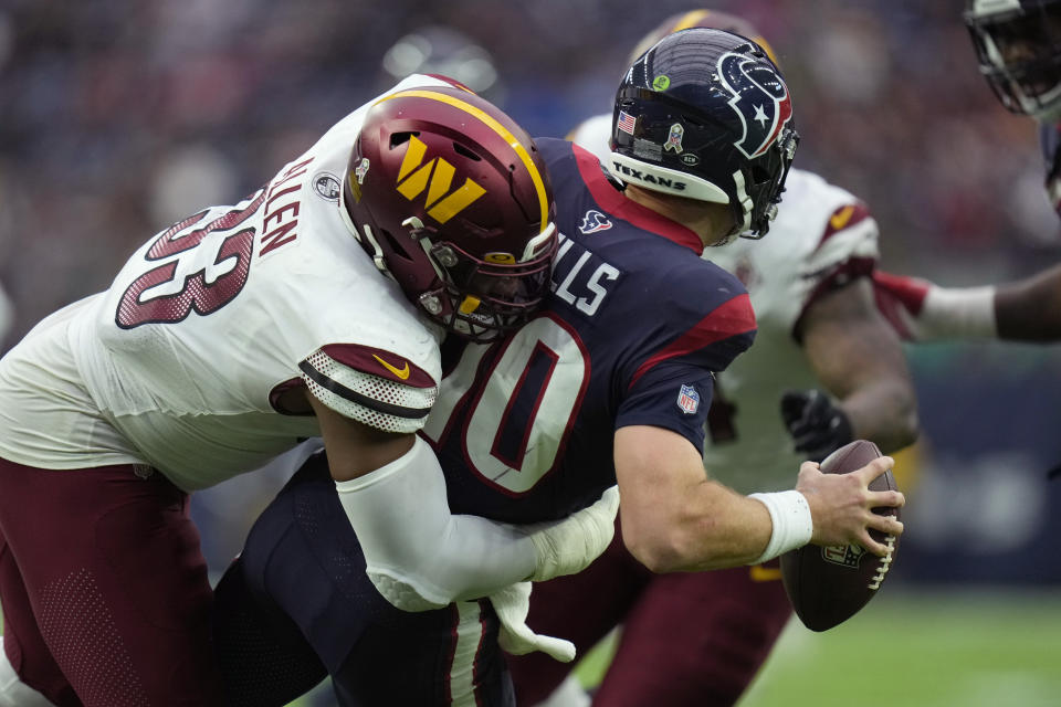 Houston Texans quarterback Davis Mills (10) is sacked by Washington Commanders defensive tackle Jonathan Allen (93) during the second half of an NFL football game Sunday, Nov. 20, 2022, in Houston. (AP Photo/Eric Christian Smith)