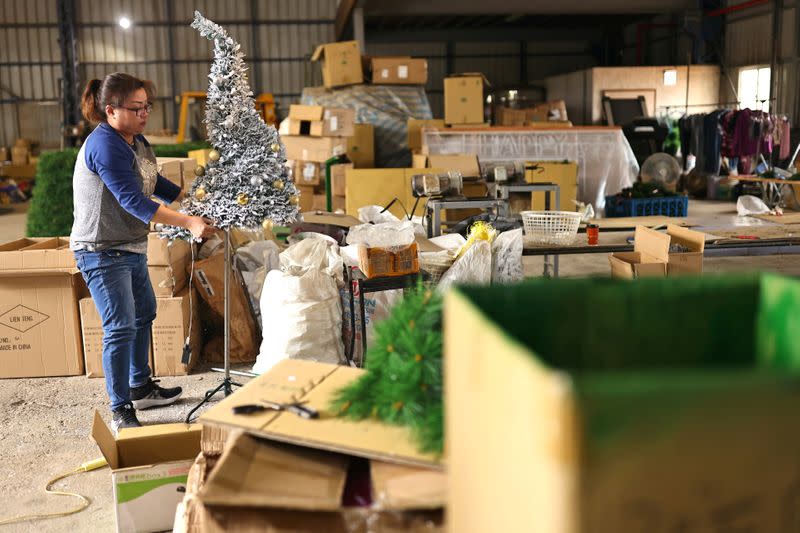 FILE PHOTO: An employee prepares a Christmas tree to be packed at the factory of Lien Teng Enterprise in Taichung, Taiwan