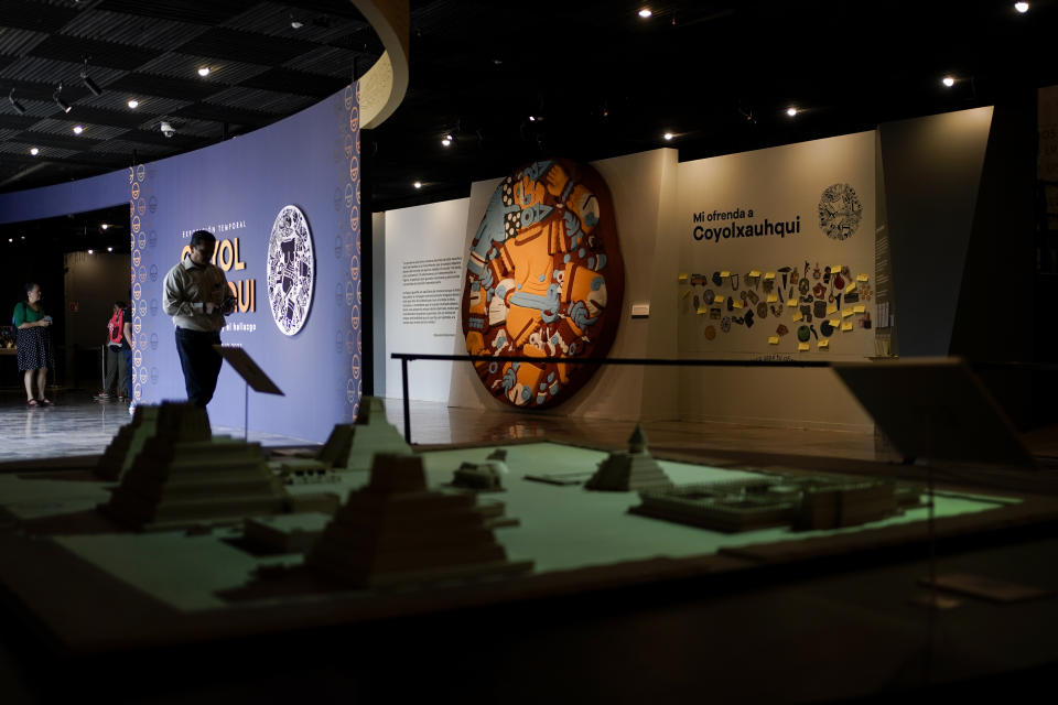 Visitors arrive at the “Coyolxauhqui: The star, the goddess, the discovery” exhibition at the Museum of Templo Mayor, in Mexico City, Wednesday, March 29, 2023. The exhibit marks the 45th anniversary of the discovery of a monolith depicting Coyolxauhqui, the Mexica lunar goddess. (AP Photo/Eduardo Verdugo)