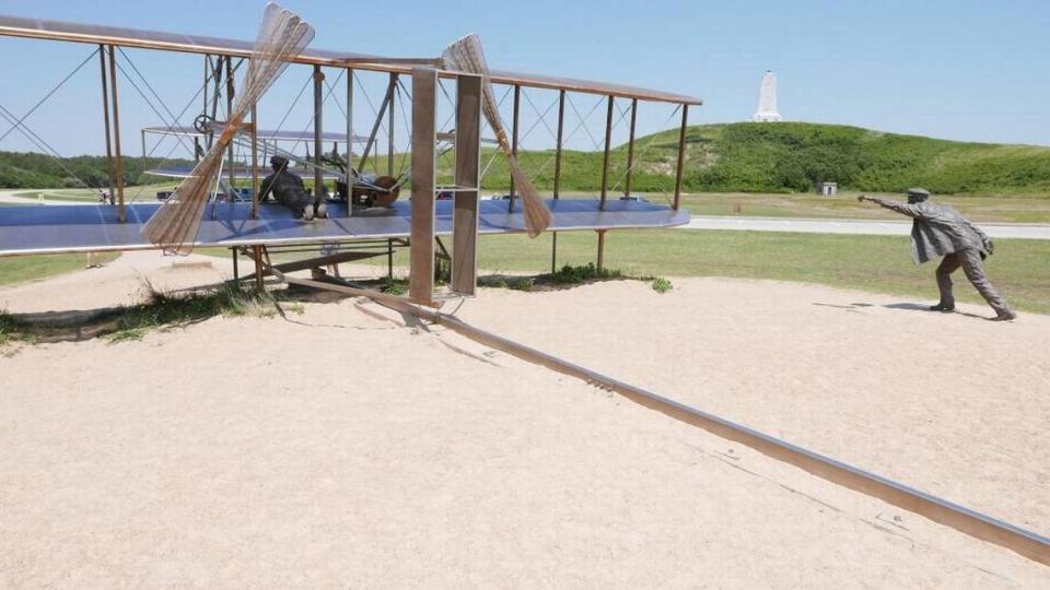 A sculpture at the Wright Brothers National Memorial depicts the 1903 first flight of Orville and Wilbur Wright at what is today known as Kill Devil Hill, North Carolina.