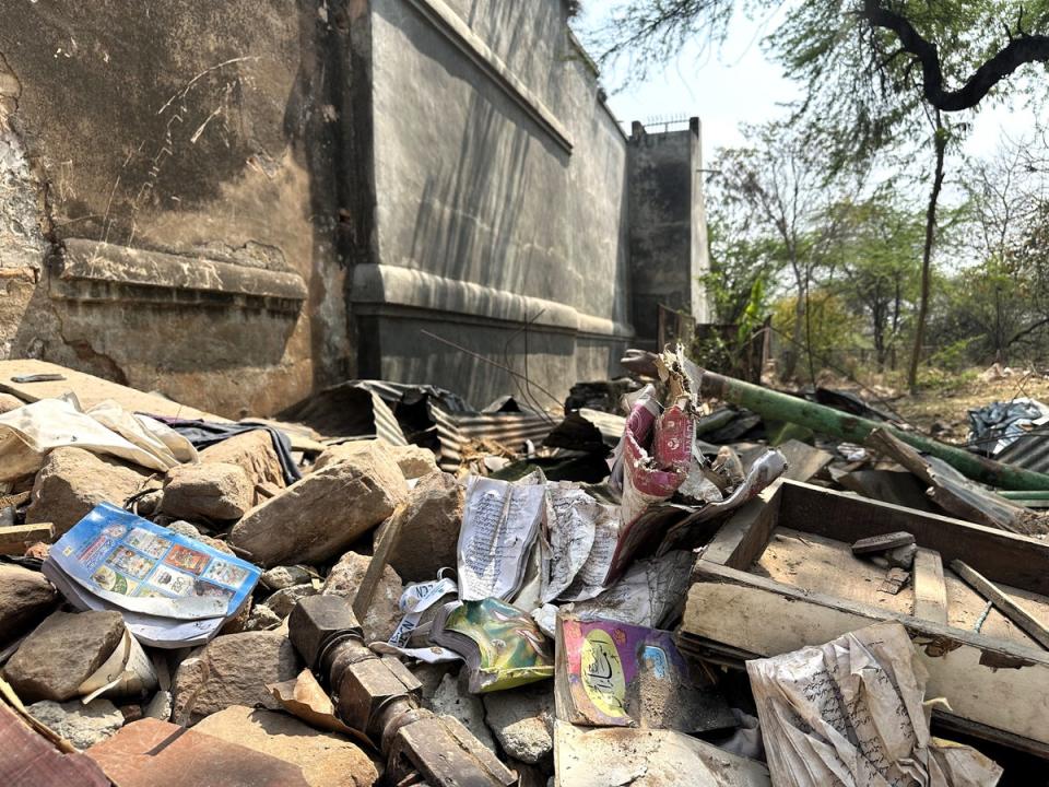 Rubble from the Akhoondji Mosque strewn with books from the associated Islamic school (Shweta Sharma/The Independent)