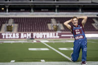 Texas A&M University Head Yell Leader Keller Cox performs a yell as part of the first Midnight Yell Practice this season in Kyle Field, College Station, Texas early Saturday, Sept. 26, 2020. Due to Coronavirus restrictions, the Texas A&M Band were the only crowd allowed in the normally packed stands for the traditional game day event in College Station, Texas. (Sam Craft/Pool Photo via AP, Pool)