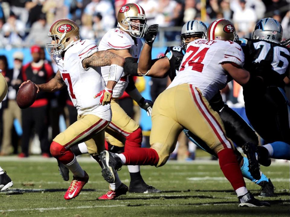 San Francisco 49ers quarterback Colin Kaepernick (7) moves out of the pocket against the Carolina Panthers during the first half of a divisional playoff NFL football game, Sunday, Jan. 12, 2014, in Charlotte, N.C. (AP Photo/Chuck Burton)