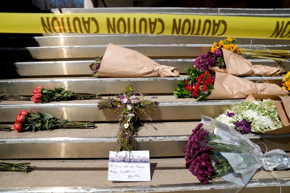 Jayne Hines placed a cross and a note outside of the Old National Bank on April 11, a day after a mass shooting that left six dead, including the shooter, and another 8 injured.