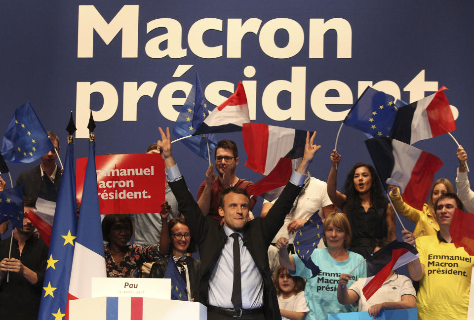 French centrist presidential election candidate Emmanuel Macron makes the "V" of the victory after his delivers a speech at a meeting in Pau, southwestern France, Wednesday, April 12, 2017. The two-round presidential election is set for April 23 and May 7. (AP Photo/Bob Edme)