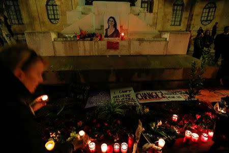 People place candles at a memorial for investigative journalist Daphne Caruana Galizia, who was murdered in a car bomb attack, during a vigil in Valletta, Malta November 16, 2017. REUTERS/Darrin Zammit Lupi - RC1963DA1730