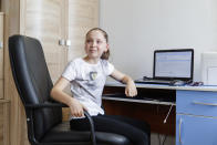 Alexandra Kustova, speaks during her interview in her family's apartment in Yekaterinburg, a city in the Urals, Russia on Thursday, May 7, 2020. For 12-year-old Alexandra, self-isolation during the coronavirus pandemic turned out to be a blessing in disguise. Now that all the studies are conducted online, not only does she have more time for her two favorite hobbies _ ballet and jigsaw puzzles _ she spends more time with her family and helps out her grandmother, who lives in the same building two floors down. (AP Photo/Anton Basanaev)