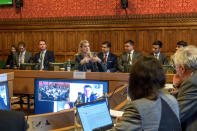 In this handout photo provided by UK Parliament, Facebook whistleblower Frances Haugen, center, gives evidence to the joint committee for the Draft Online Safety Bill, as part of government plans for social media regulation, in London, Monday, Oct. 25, 2021. Haugen said Monday that Facebook is making online hate and extremism worse and outlined how it could improve online safety. (Annabel Moeller/UK Parliament via AP)