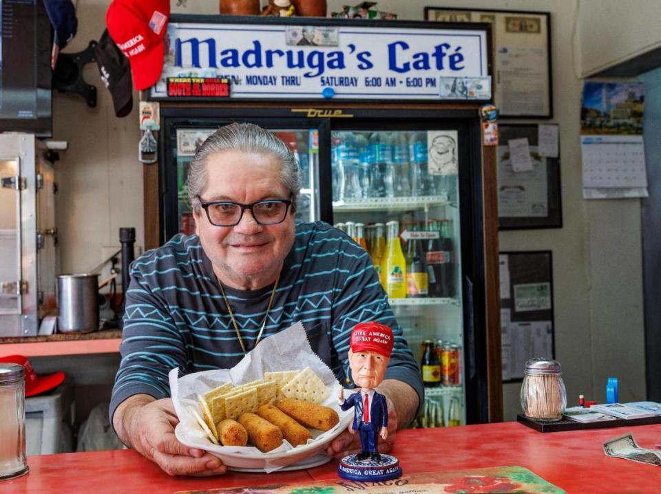 Owner Alberto Madruga displays a dish of “Trump Croquettes” from the menu of the Madruga’s Cafe, on Feb. 09, 2024. Pedro Portal/pportal@miamiherald.com