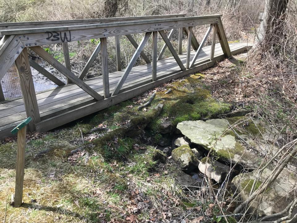 A bridge crosses Crooked Brook, which flows across the property and empties into Pettaquamscutt Cove.