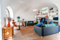 <p>The two-bedroom home boasts a spacious interior, thanks to its high, curved ceilings, and a colourful decor. (Airbnb) </p>