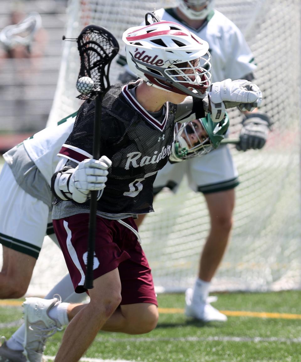 Scarsdale's Jacob Goldstein (6) has his helmet knocked by Shenendehowa's Logan Linn (24) resulting in a first-half penalty during the boys lacrosse Class A regional final at Shaker High School in Albany on Saturday. Scarsdale won the game 14-6.