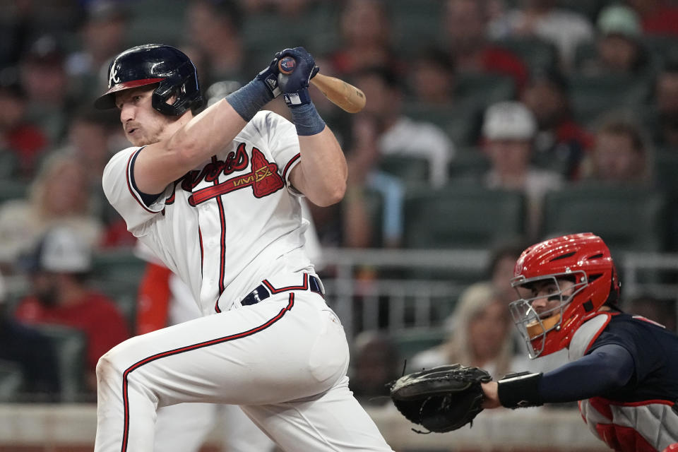 Atlanta Braves' Sean Murphy (12) drives in two runs with a base hit as Boston Red Sox catcher Reese McGuire (3) looks on in the fourth inning of a baseball game Tuesday, May 9, 2023, in Atlanta. (AP Photo/John Bazemore)