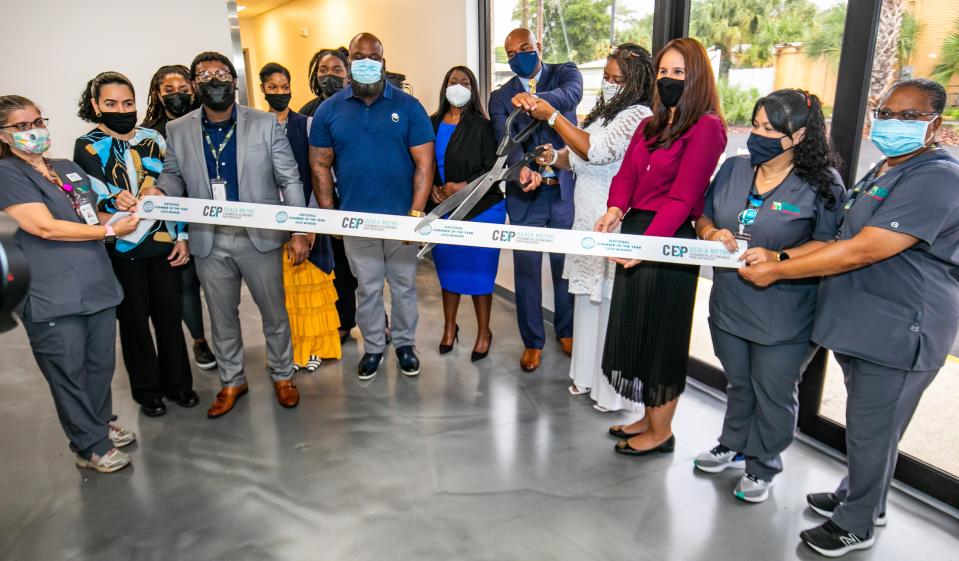 Members of the Ocala/Marion County Chamber and Economic Partnership and the Heart of Florida Health Center cut the ribbon on HFHC's new drive-thru pharmacy in August.