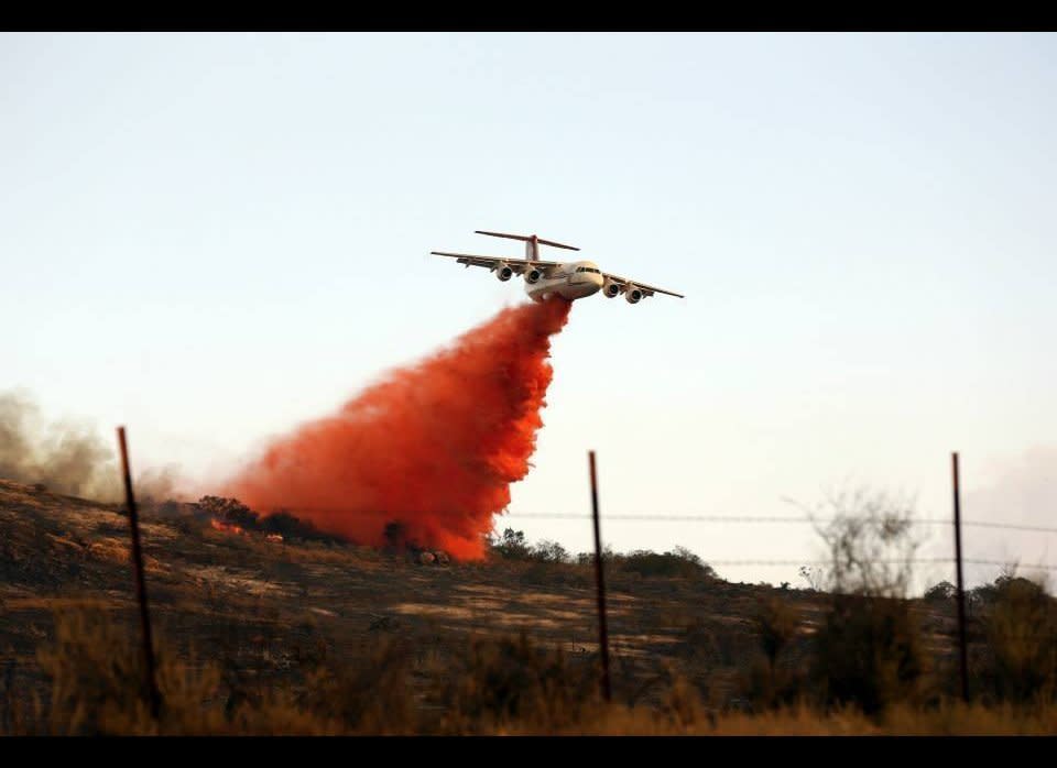 U.S. Marines and fire crew on Marine Corps Base Camp Pendleton, Calif., respond to wildfires ablaze in southern California May 14, 2014. The Tomahawk fire, in the northeast section of Camp Pendleton has burned more than 6,000 acres forcing evacuations of housing areas on base and various schools both on and off base. Aircraft from 3rd Marine Aircraft Wing and the Camp Pendleton Fire Department worked in coordination with CALFIRE to prevent fires from spreading off base. Marine officials are coordinating with CALFIRE for the further use of military aircraft pending the wildfire status within San Diego County.  Photo by Cpl. Orrin Farmer