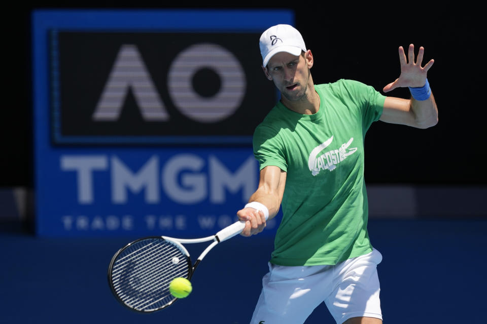 FILE - Defending men's champion Serbia's Novak Djokovic practices on Margaret Court Arena ahead of the Australian Open tennis championship in Melbourne, Australia, Thursday, Jan. 13, 2022. Athletes have been put at center court of arguments over COVID vaccines. The NFL's Aaron Rodgers, the NBA's Kyrie Irving, and tennis's Novak Djokovic, have each become cultural touchstones in the cultural controversy. (AP Photo/Mark Baker, File)