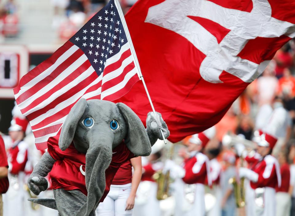 Big Al carries the American flag in memory of those who lost their lives in the terror attacks of 9-11 in 2001 as he runs onto the field Saturday, Sept. 11, 2021, in Bryant-Denny Stadium. [Staff Photo/Gary Cosby Jr.]