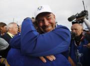 Golf - 2018 Ryder Cup at Le Golf National - Guyancourt, France - September 30, 2018. Team Europe's Francesco Molinari celebrates with captain Thomas Bjorn after winning the Ryder Cup REUTERS/Carl Recine