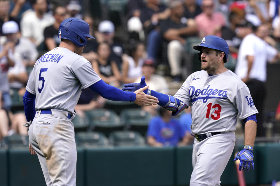 Los Angeles Dodgers' Max Muncy (13) celebrates with Freddie Freeman his three-run home run off Chicago White Sox relief pitcher Bennett Sousa during the sixth inning of a baseball game Thursday, June 9, 2022, in Chicago. (AP Photo/Charles Rex Arbogast)