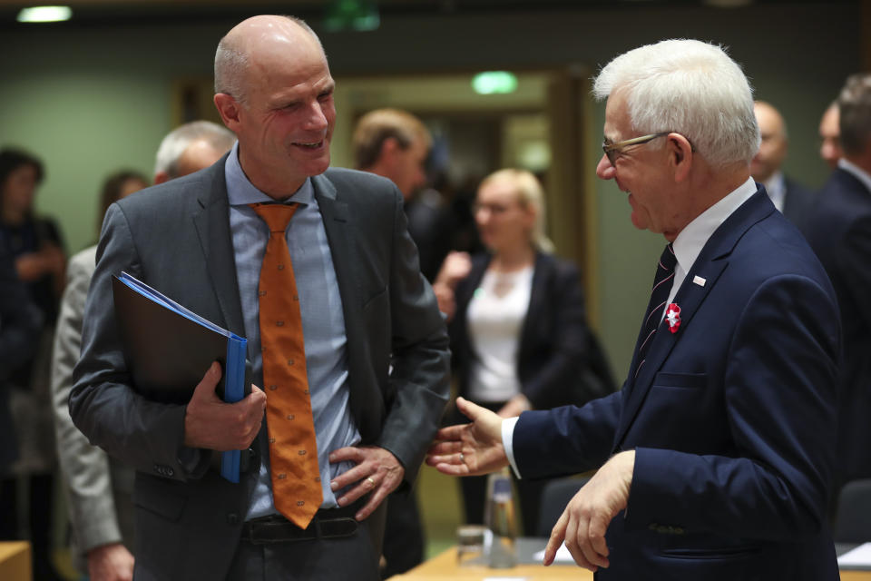 Dutch Foreign Minister Stef Blok, left, talks to Polish Foreign Minister Jacek Czaputowicz during an European Foreign Affairs Ministers meeting at the Europa building in Brussels, Monday, Nov. 11, 2019. European Union foreign ministers are discussing ways to keep the Iran nuclear deal intact after the Islamic Republic began enrichment work at its Fordo power plant. (AP Photo/Francisco Seco)