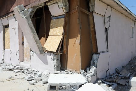 A house is left destroyed by an earthquake, triggered by a previous day quake, near the epicenter in Trona, California