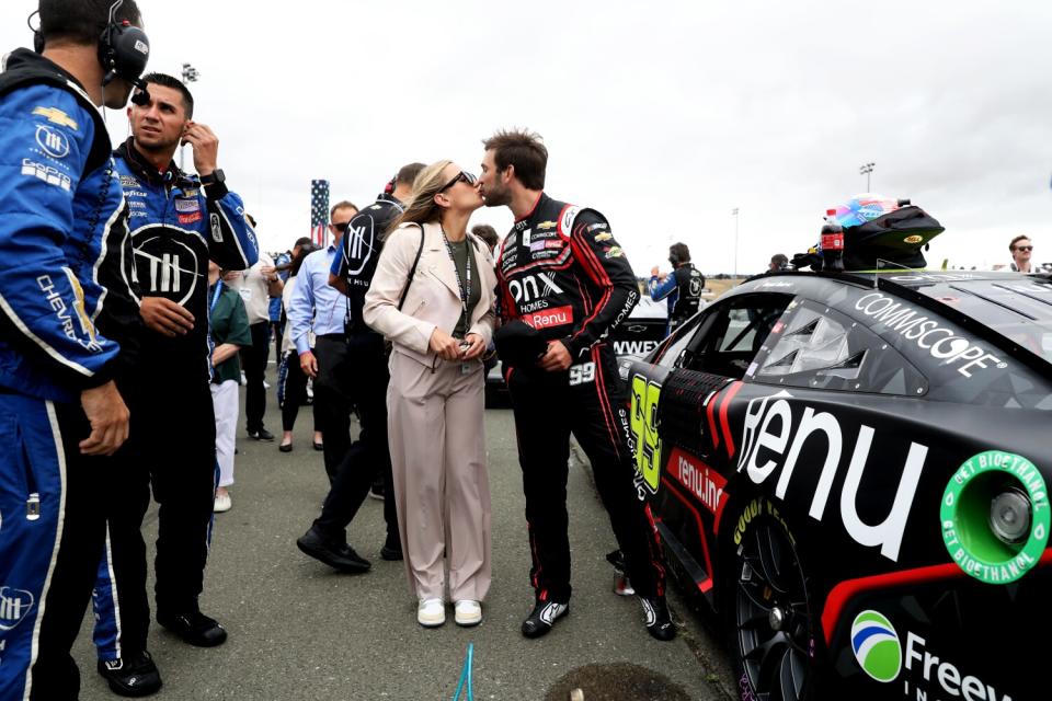 Daniel Suárez celebrates with the winner's trophy after his first career NASCAR Cup victory.