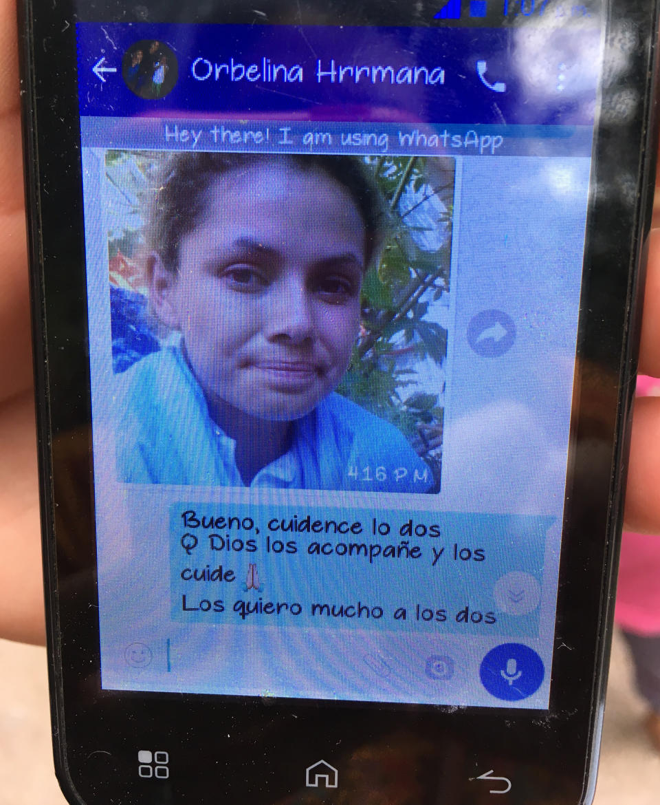 In this Nov. 2, 2018 photo, Deysi Orellana shows her smartphone at her home in San Pedro Sula, Honduras, to share a whatsapp chat with her sister Orbelina Orellana, pictured, who was in an unknown location in southern Mexico, traveling with her husband in the Central American migrant caravan. Like thousands of others, Orellana and her husband have relied on social media, text messages and brief phone calls to connect with worried loved ones back home as they traverse a country that can often be deadly for migrants. The message from Deysi to Orbelina reads in Spanish: "Okay, you two take care of yourselves. May God keep you in his care. I love you both very much." (AP Photo/Maria Verza)